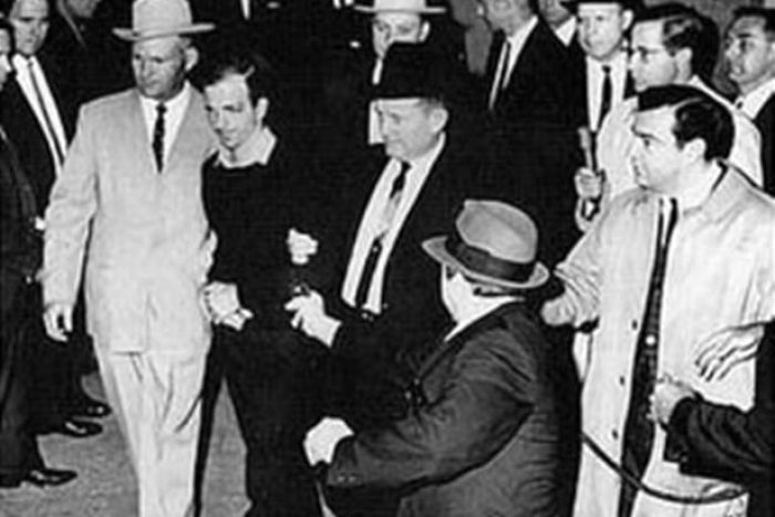 Lee Harvey Oswald is shot by Jack Ruby in the basement of Dallas Police Headquarters.