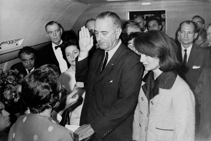 Lyndon Johnson takes the oath of office on Air Force One at Love Field Airport.