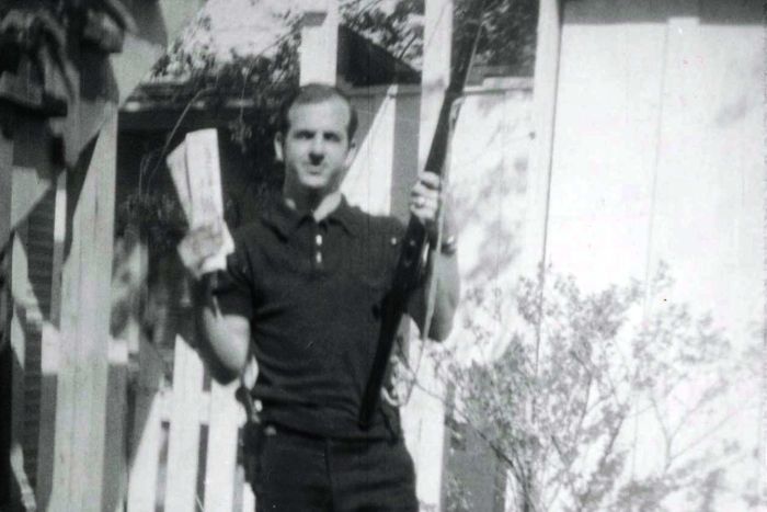 Lee Harvey Oswald holding rifle and "Communist newspapers"