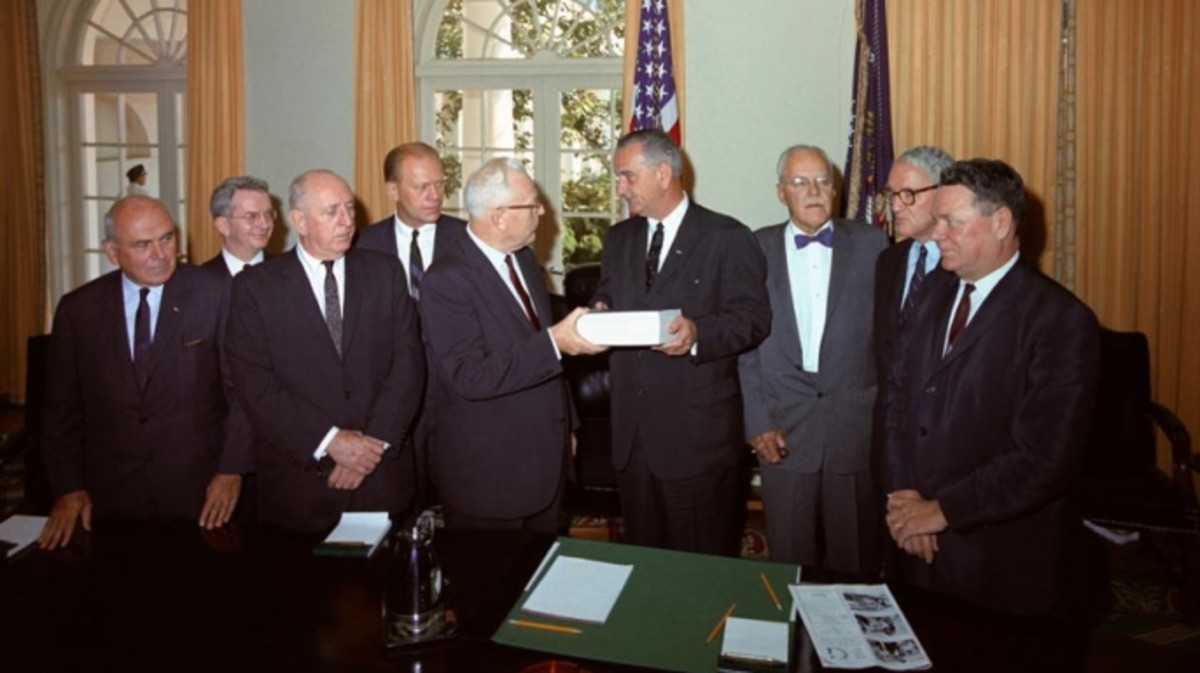 The Warren Commission presents it finding to President Lyndon Johnson.