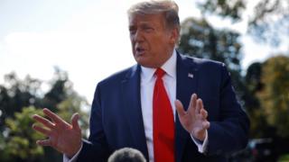 US President Donald Trump talks reporters as he departs on campaign travel to Minnesota from the South Lawn at the White House in Washington.