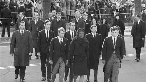 President John F. Kennedy's widow and his brothers arrive for the funeral Mass at St. Matthew's Cathedral in Washington, Nov. 25, 1963. In front are Robert F. Kennedy, Jacqueline Kennedy, and Edward M. Kennedy. In between and behind Robert and Mrs. Kennedy is Sargent Shriver. President and Mrs. Lyndon Johnson are in the background. Others are unidentifed.