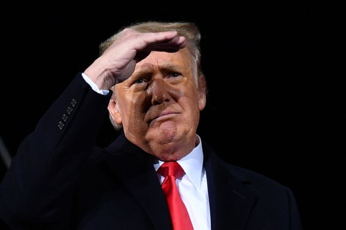 President Donald Trump looks on during a rally in support of Republican incumbent senators Kelly Loeffler and David Perdue. (Photo by MANDEL NGAN/AFP via Getty Images)