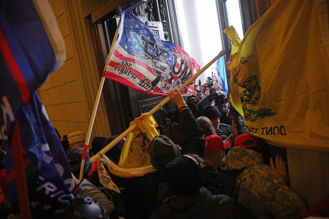 Protesters supporting U.S. President Donald Trump break into the U.S. Capitol on Wednesday, Jan. 6, 2021 in Washington, D.C. Congress held a joint session today to ratify President-elect Joe Biden's 306-232 Electoral College win over President Donald Trump. A group of Republican senators said they would reject the Electoral College votes of several states unless Congress appointed a commission to audit the election results. (Win McNamee/Getty Images/TNS)