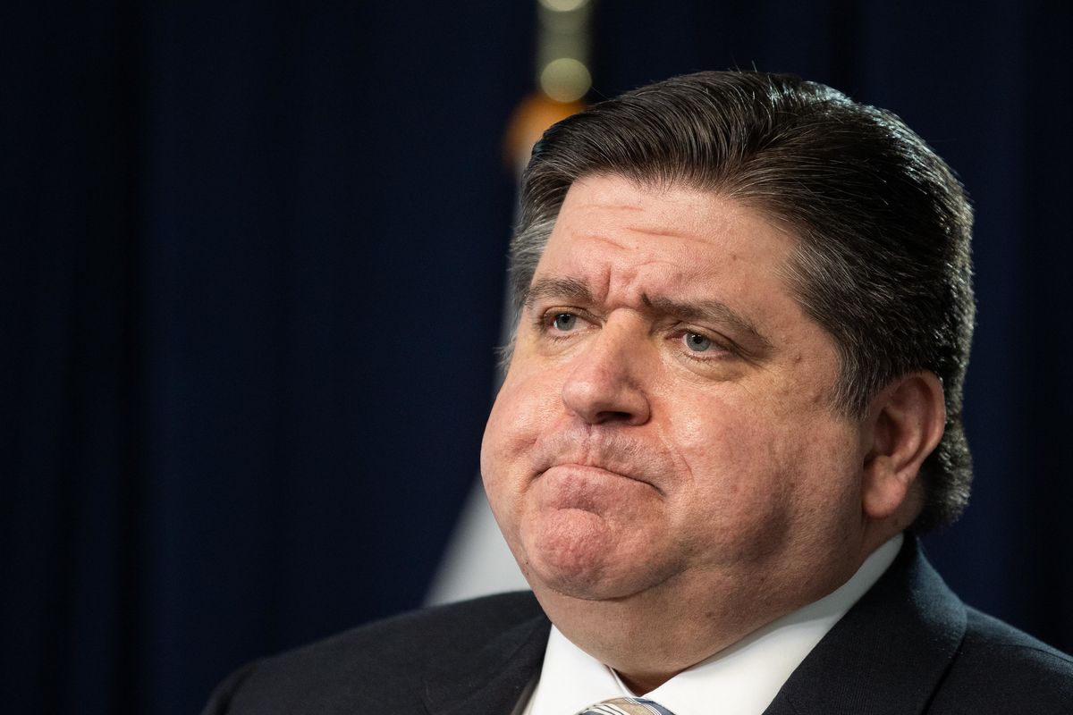 Gov. J.B. Pritzker listens at a March 18 COVID-19 news conference. His health team has given local health department more leeway to expand vaccine eligibility as cases rise across the state.