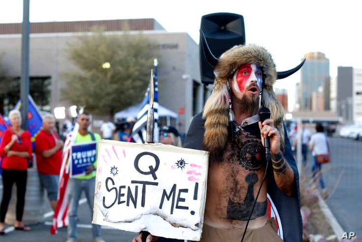 FILE - In this Nov. 5, 2020, file photo, Jacob Anthony Chansley, who also goes by the name Jake Angeli, a Qanon believer speaks…