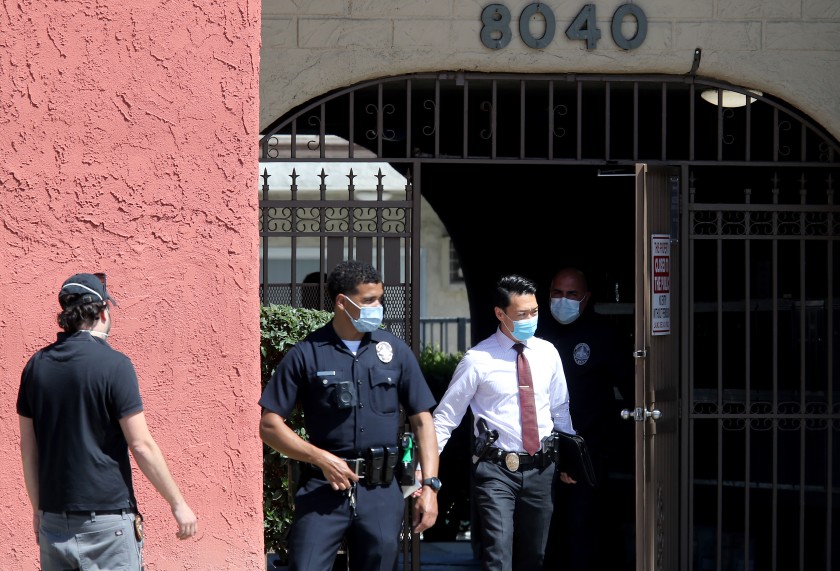 Police conduct an investigation at an apartment building.