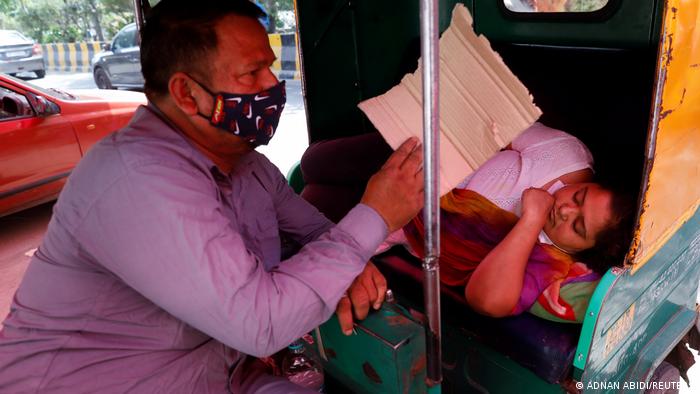 A sick woman in a rickshaw