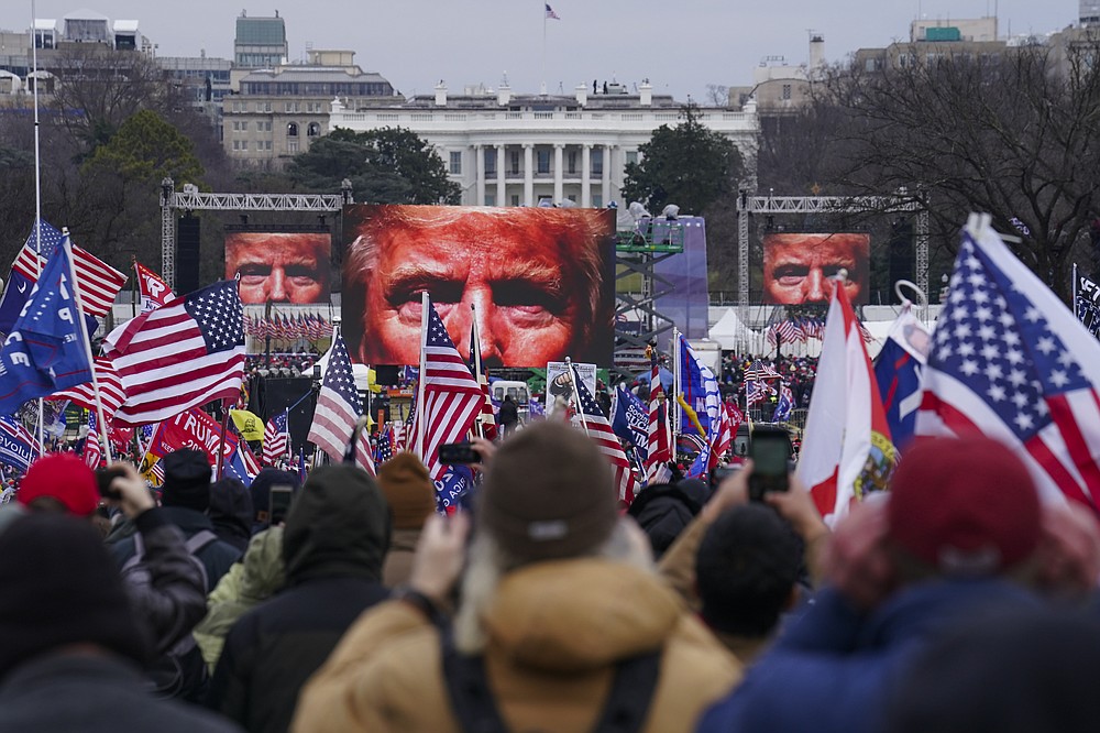 FILE - In this Jan. 6, 2021 file photo, Trump supporters participate in a rally in Washington. Many of those who stormed the Capitol on Jan. 6 cited falsehoods about the election, and now some of them are hoping their gullibility helps them in court. Attorneys for several defendants facing charges connected to the deadly insurrection say they will raise their client's belief in conspiracy theories and misinformation, either as an explanation for why they did what they did, or as an attempt to create a little sympathy. (AP Photo/John Minchillo, File)