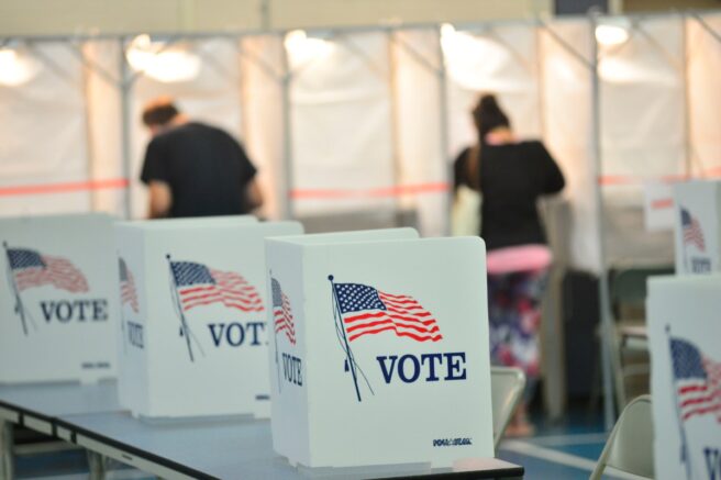 File- Voting booths are kept socially distant at the Chesterfield, N.H. polling site. (Kristopher Radder/The Brattleboro Reformer via AP Photo)