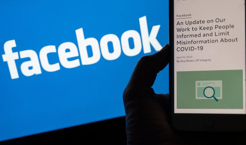 A smart phone screen showing a new Facebook policy on Covid-19 misinformation