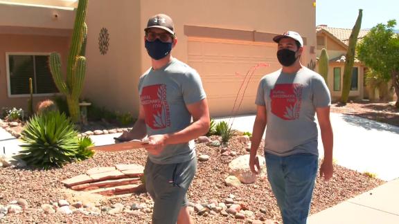 Calden Rasmussen, left, is one of dozens of volunteers seeking signatures to recall Arizona state Rep. Mark Finchem.