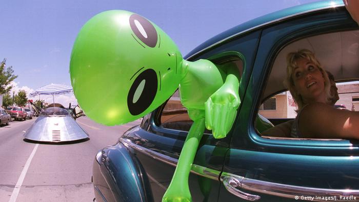 An alien doll hangs out a car window in downtown Roswell, New Mexico