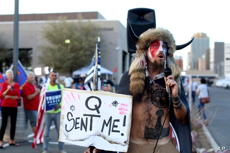 FILE - In this Nov. 5, 2020, file photo, Jacob Anthony Chansley, who also goes by the name Jake Angeli, a Qanon believer speaks…