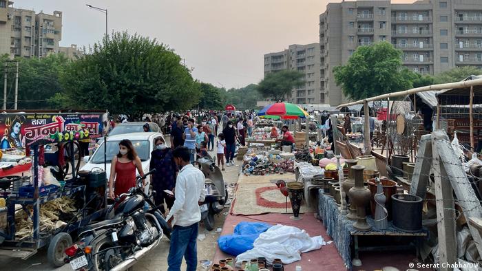 People step out as shops and markets reopen in India's national capital region after weeks of lockdown