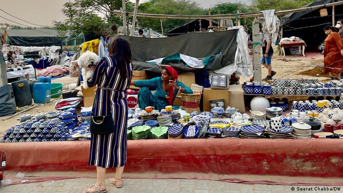 A woman with her dog in Gurgaon's Banjara market