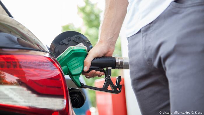 A man pumping gas