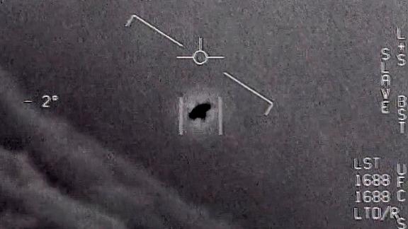 The image from video provided by the Department of Defense shows an unexplained object as it soars high along the clouds, traveling against the wind. 