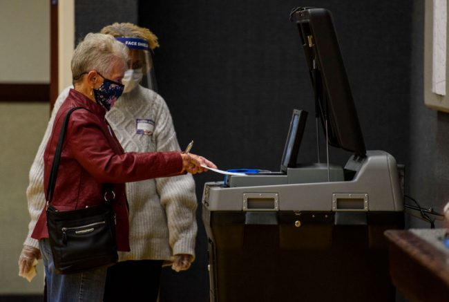 FAYETTEVILLE, NC - NOVEMBER 03: Dorothy Higginbotham, 90 years old, places her ballot into a tabulating machine on Election Day at Church of Jesus Christ of latter-day Saints on November 3, 2020 in Fayetteville, North Carolina. After a record-breaking early voting turnout, Americans head to the polls on the last day to cast their vote for incumbent U.S. President Donald Trump or Democratic nominee Joe Biden in the 2020 presidential election. (Photo by Melissa Sue Gerrits/Getty Images)