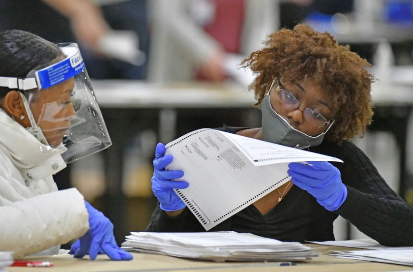 Two Fulton County, Ga., election officials working on a hand recount of ballots.