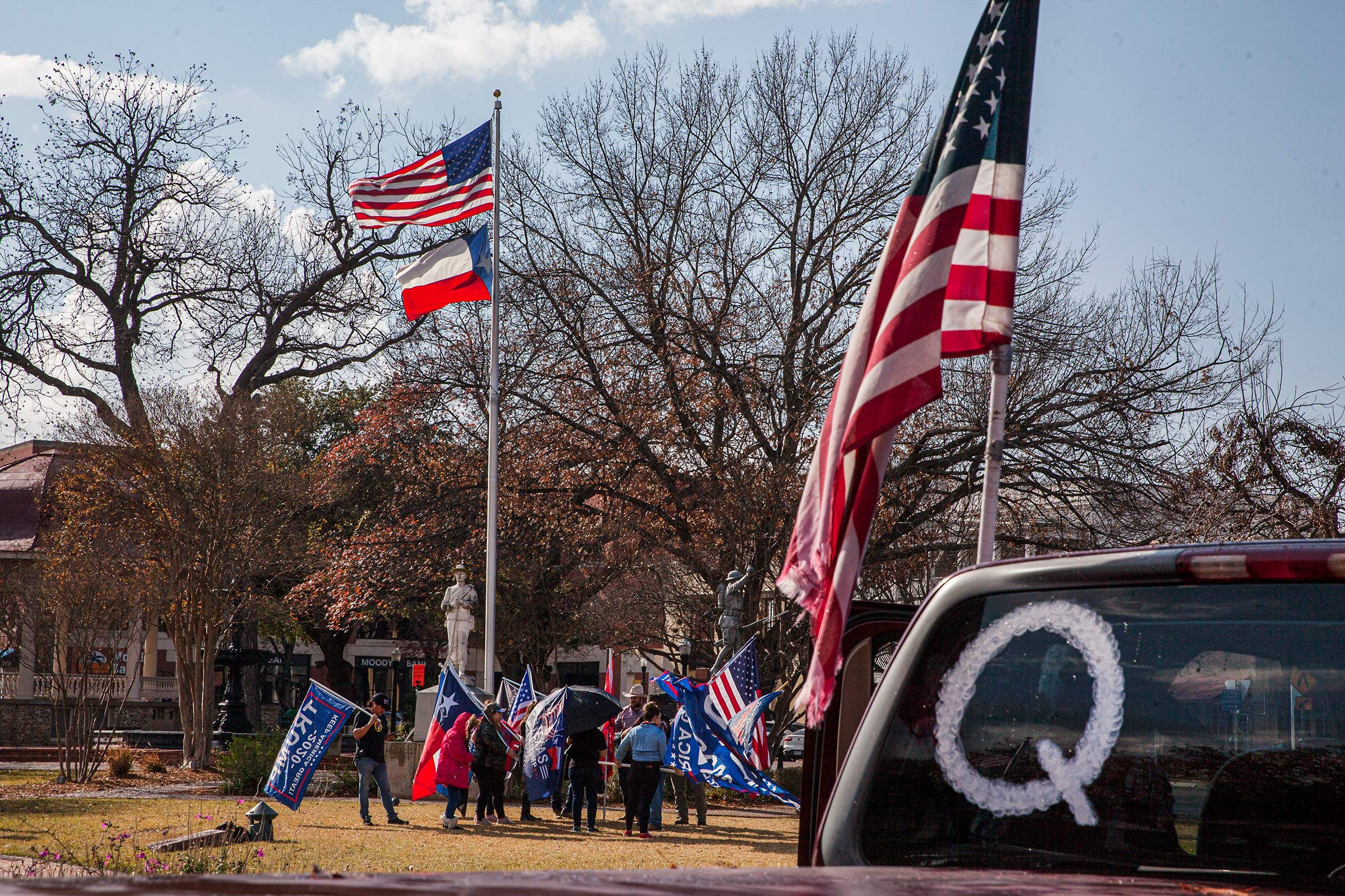 A QAnon symbol is displayed on a car as New Braunfels Trump Train members meet in support of President Trump at the Main Plaza on January 6, 2021 in New Braunfels.