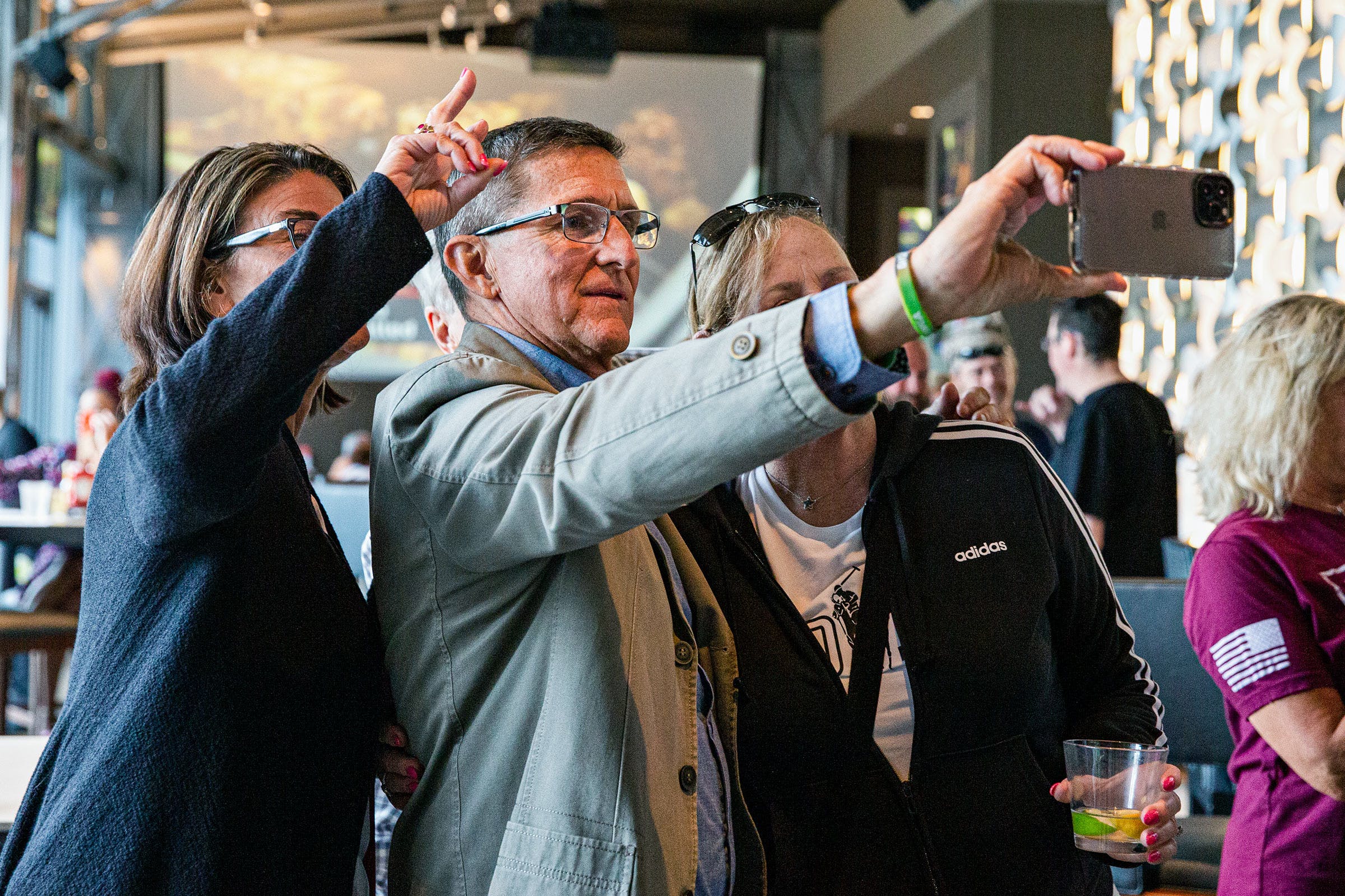 Former national security adviser Michael Flynn takes a selfie at the For God & Country Patriot Roundup convention, In Dallas, on May 28, 2021.