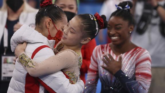 Chinese gymnasts Tang Xijing and Guan Chenchen, and US gymnast Simone Biles celebrate after the women's balance beam final at the Tokyo Olympics on August 3. 