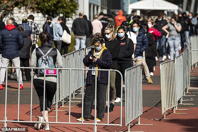 People line up outside the Covid vaccination hub at the Royal Melbourne Showgrounds in Melbourne on Wednesday