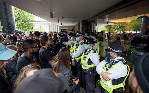 Anti-vax protestors are confronted by police outside BBC offices in White City, west London