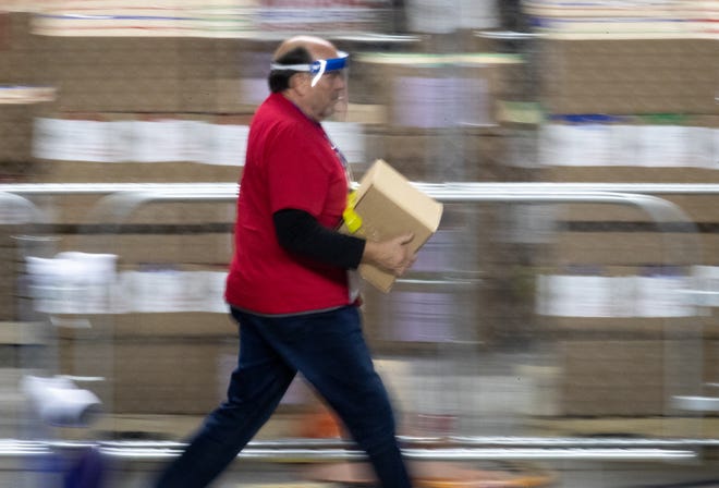 A box of Maricopa County ballots cast in the 2020 general election are delivered to be examined and recounted by contractors hired by the Arizona senate, June 15, 2021, at the Veterans Memorial Coliseum, Phoenix.