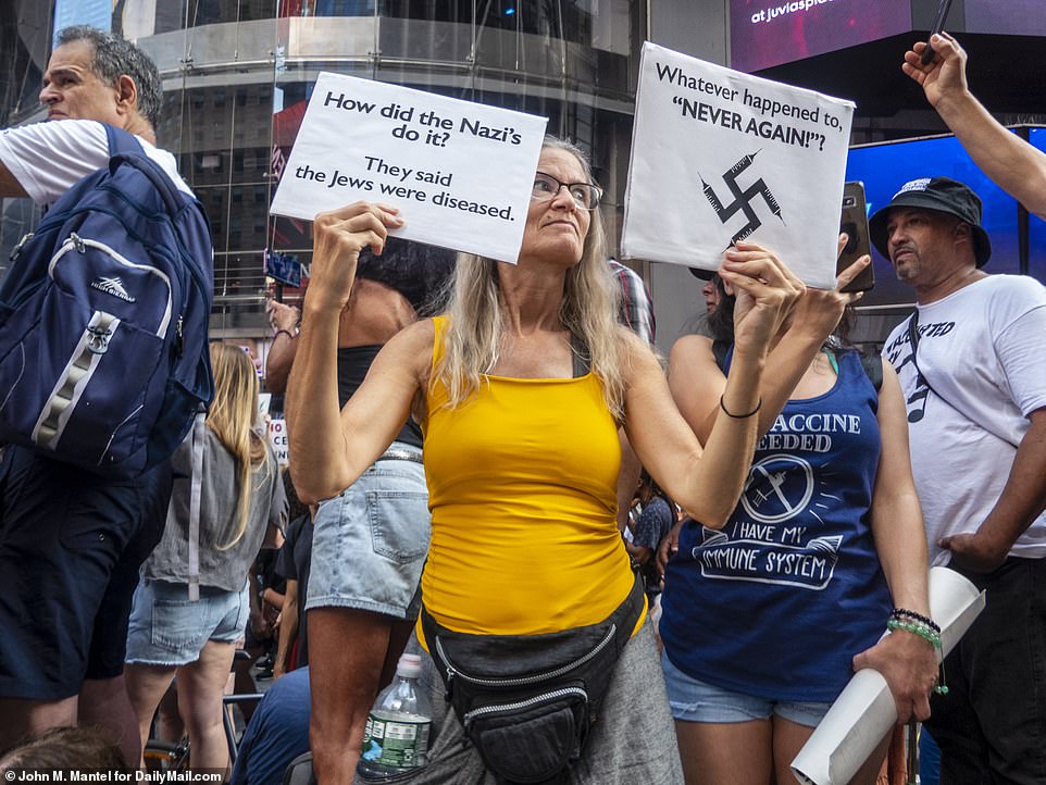 Anti-vaccine mandate protesters gathered in Times Square to protest New York's Covid-19 vaccine mandate - and one woman likened the rule to hardships suffered by Jews in Nazi Germany