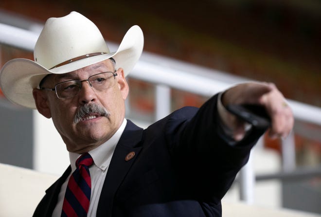 State Rep. Mark Finchem, R-Oro Valley, a candidate for Arizona secretary of state, points from the press viewing area, as Maricopa County ballots from the 2020 general election are examined and recounted by contractors hired by the Arizona Senate in an audit at the Veterans Memorial Coliseum in Phoenix on May 11, 2021.