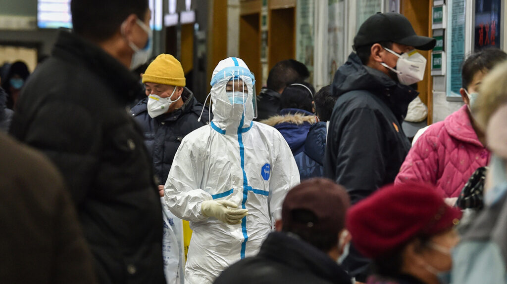 person wearing hazmat suit in crowd 