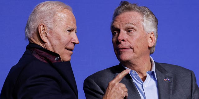 President Biden and Democratic candidate for governor of Virginia Terry McAuliffe interact onstage at a rally in Arlington, Va., Oct. 26, 2021.