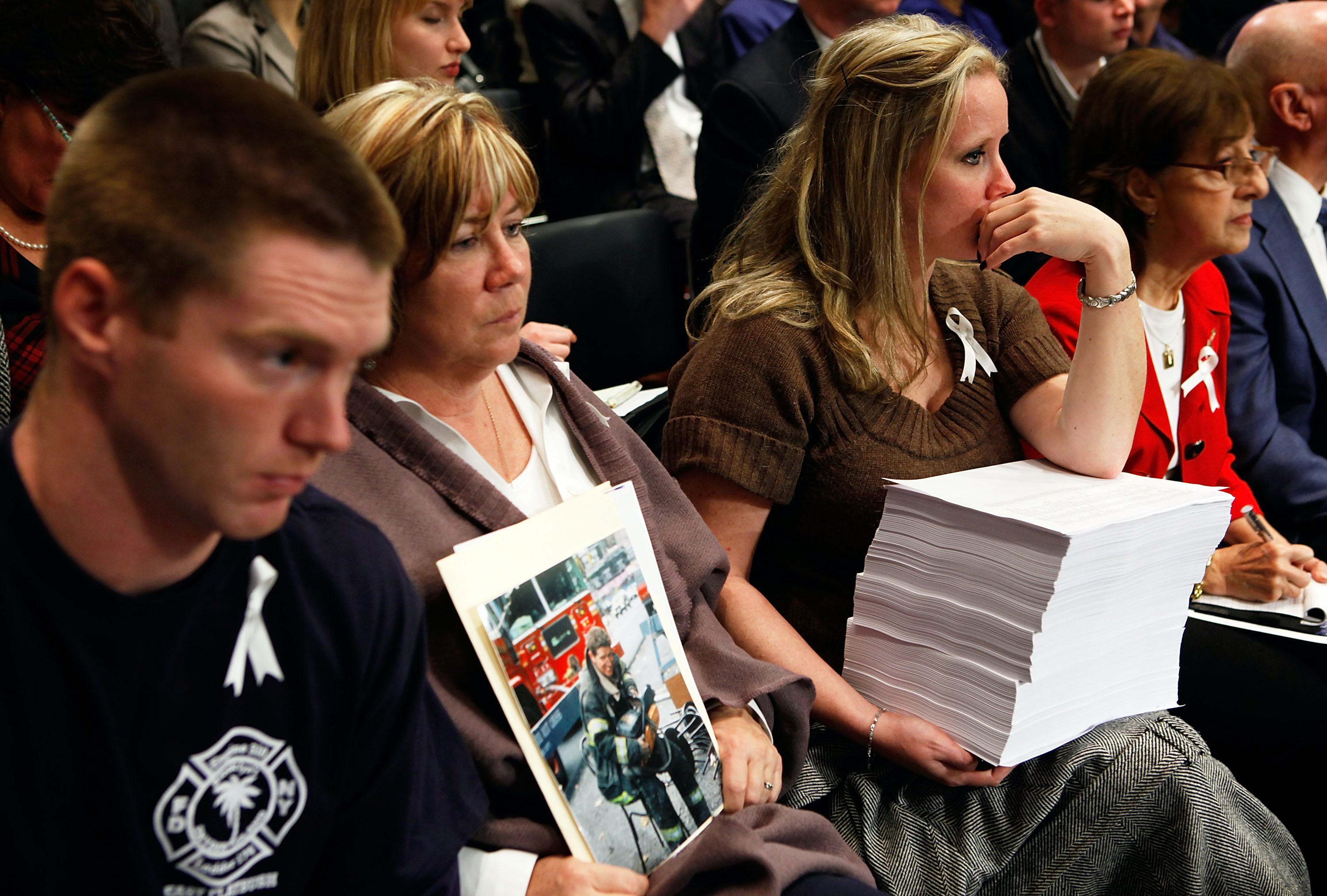 Theresa Regan (2nd L), who lost her husband and FDNY firefighter Donald Regan at the South Tower of the World Trade Center during the 9/11 terrorists attacks, listens with her son Peter (L) and daughterJill (3rd L) during a hearing before the Senate Judiciary Committee on Capitol Hill November 18, 2009 in Washington, DC.