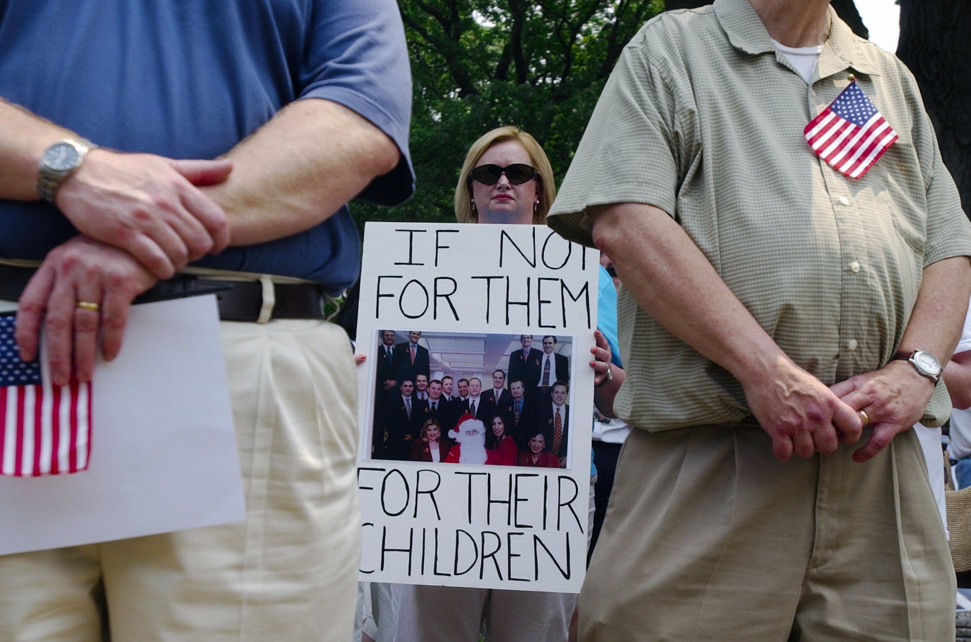 UNITED STATES - NOVEMBER 23: Colleen Ryan of New Jersey, holds a photo of an office staff in which all but two parished in the attacks on the World Trade Center including her brother John J. Ryan. Families of Sept. 11 victims gathered on Upper Senate Park, Tuesday, to urge Congress to set up a commission to investigate the events that led up to the terrorist attacks. (Photo By Tom Williams/Roll Call/Getty Images)