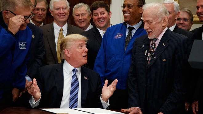 President Donald Trump talks with astronaut Buzz Aldrin before signing an order establishing a National Space Council, June 30, in Washington. (AP Photo/Evan Vucci)