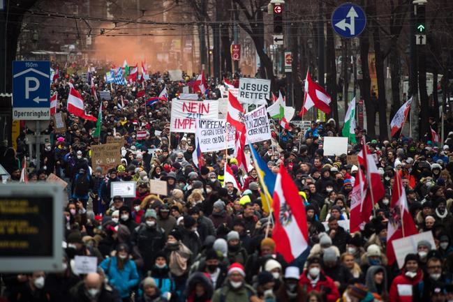 Crowds protesting against lockdown measures and vaccination mandates march through Vienna in December last year. 