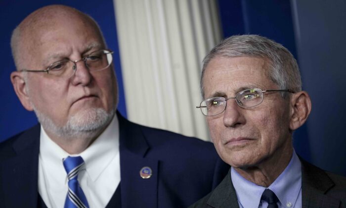 (L-R) Robert Redfield, director of the Centers for Disease Control and Prevention, and Dr. Anthony Fauci, director of the National Institute of Allergy and Infectious Diseases, attend a briefing on the administration's CCP virus response in the press briefing room of the White House in Washington on March 2, 2020. (Drew Angerer/Getty Images)