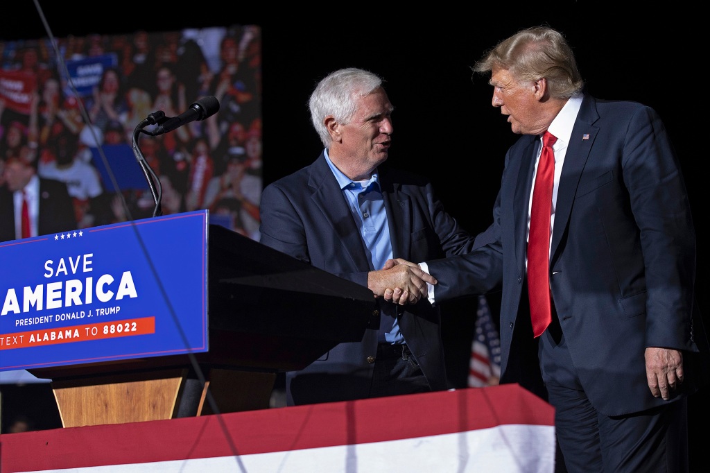 Former U.S. President Donald Trump (right) welcomes candidate for U.S. Senate and U.S. Rep. Mo Brooks (left) during a "Save America" rally at York Family Farms on August 21, 2021.