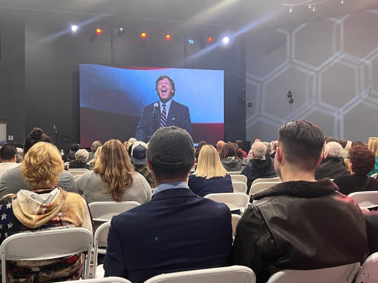 Pastors Jurgen and Leanne Matthesius finished the evening with a prayer for Tucker Carlson. The crowd gathered at Awaken Church bowed their heads as Jurgen thanked the lord for Carlson's vision and honesty on April 2, 2022./ Photo by Jakob McWhinney