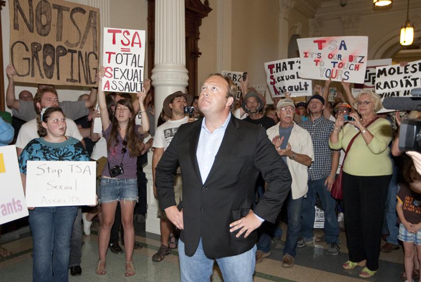 Rally organizer Alex Jones stands with anti-TSA protesters outside the House chamber after the House tentatively passed HB41…