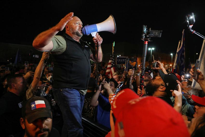 Alex Jones of Infowars speaks to supporters of U.S. President Donald Trump gather during a protest about the early results o…