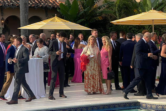 Guests stand around a pool at Mar-a-Lago.