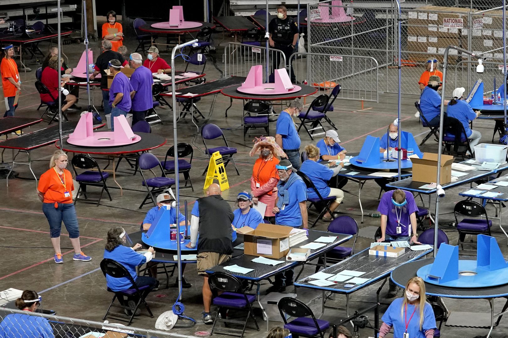 FILE - In this May 6, 2021 file photo, Maricopa County ballots cast in the 2020 general election are examined and recounted by contractors working for Florida-based company, Cyber Ninjas at Veterans Memorial Coliseum in Phoenix. The push by Republicans to conduct partisan ballot reviews like the one that unfolded last year in Arizona has spread beyond battleground states disputed by former President Donald Trump. Lawmakers in GOP-dominated state legislative chambers are calling not only for another look at the 2020 presidential election but also the ability to question future contests. (AP Photo/Matt York, Pool, File)