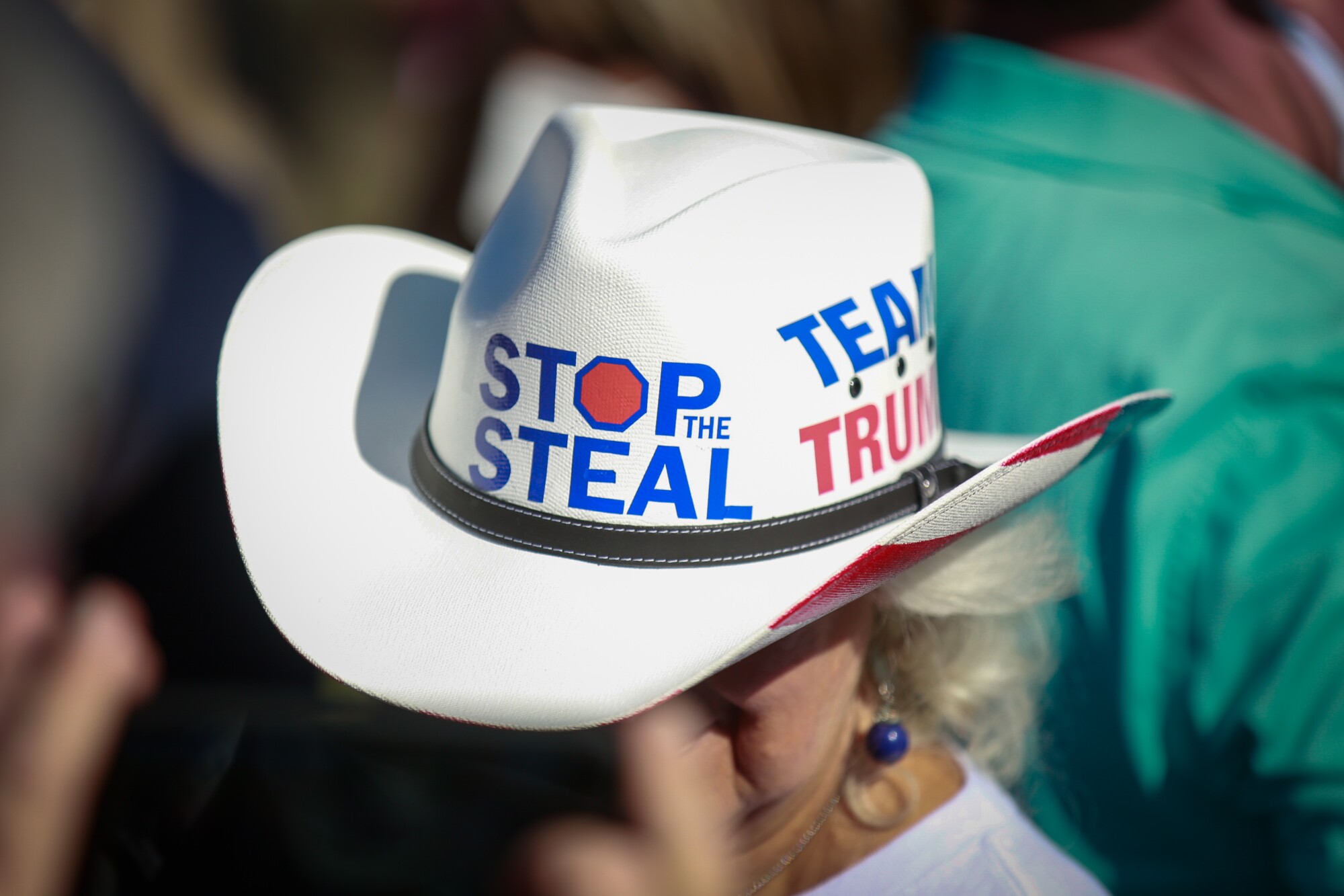 A woman in a cowboy had with the message "Stop the Steal"