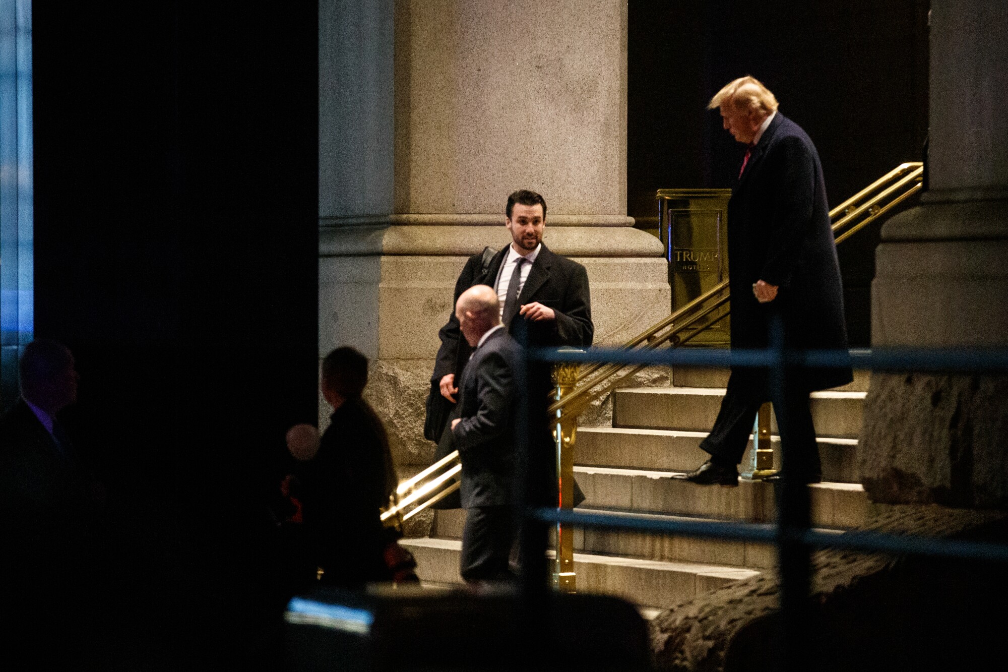 Donald Trump walks down stairs 