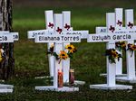 Crosses adorn a makeshift memorial for the shooting victims at Robb Elementary School. NPR has not independent verified the names.