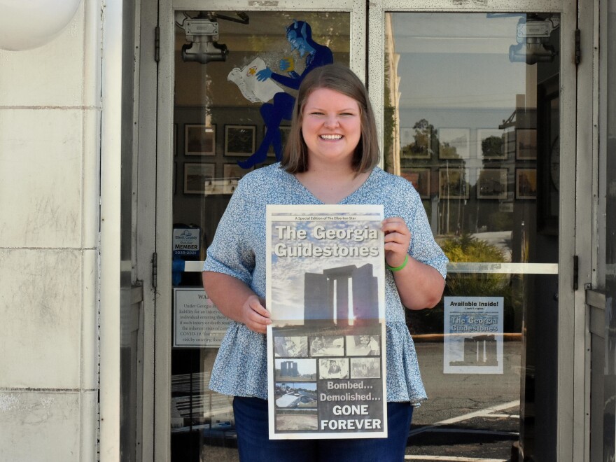 Rose Scoggins, editor of the local newspaper, with a special edition the paper put out after the monument was bombed earlier this month.