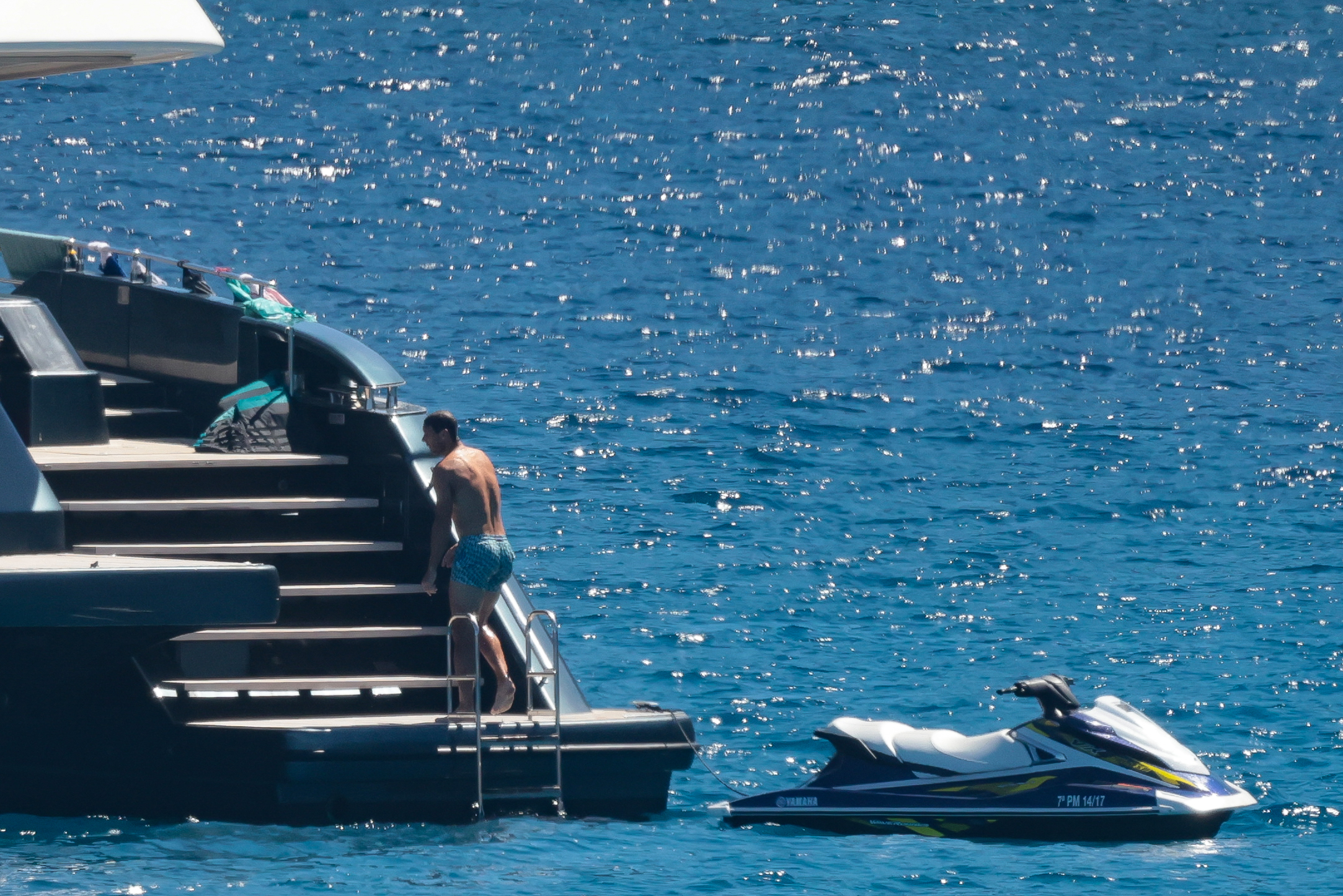 He parked his jet ski and returned to the boat after riding the waves